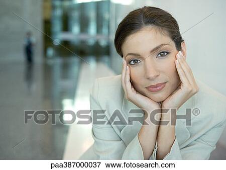 Stock Photo - Woman cupping head in hands. Fotosearch