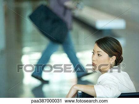 Woman sitting in airport lounge View Large Photo Image Stock Image - Woman sitting in airport lounge. Fotosearch