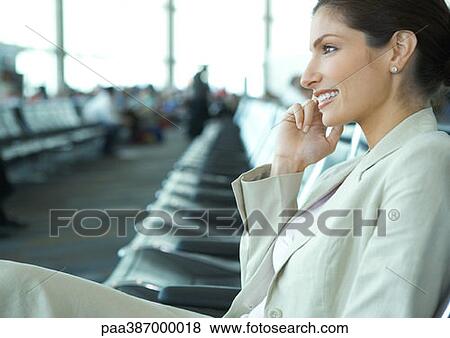 Woman sitting in airport lounge View Large Photo Image Stock Photo - Woman sitting in airport lounge. Fotosearch