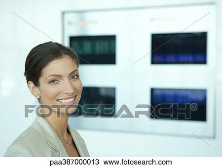 Woman smiling, departure board in background View Large Photo Image Stock Image - Woman smiling, departure board in background. Fotosearch