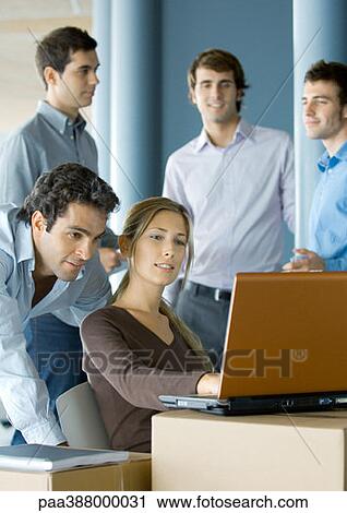 Business people using laptop on cardboard box View Large Photo Image Stock Image - Business people using laptop on cardboard box. Fotosearch