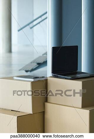 Laptop on top of stack of cardboard boxes View Large Photo Image Stock Image - Laptop on top of stack of cardboard boxes. Fotosearch