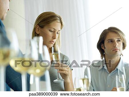 Cocktail party, focus on woman looking down View Large Photo Image Stock Photo - Cocktail party, focus on woman looking down. Fotosearch