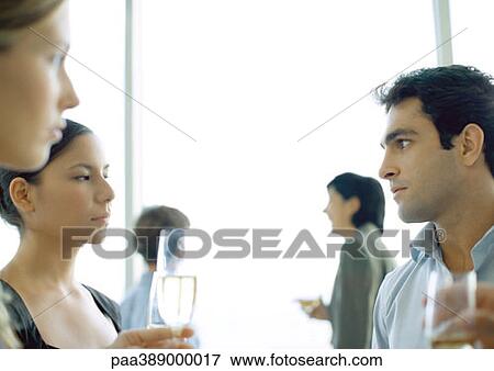 Office party, man and woman glaring at each other View Large Photo Image Stock Photo - Office party, man and woman glaring at each other. Fotosearch