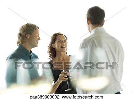 Three people chatting and drinking wine View Large Photo Image Stock Image - Three people chatting and drinking wine. Fotosearch