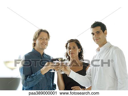 Three people clinking glasses of wine View Large Photo Image Stock Image - Three people clinking glasses of wine. Fotosearch