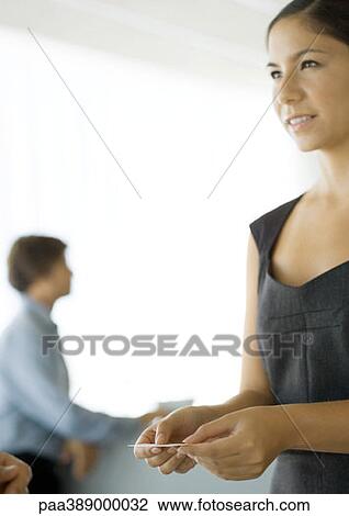 Woman holding business card, smiling View Large Photo Image Stock Image - Woman holding business card, smiling. Fotosearch