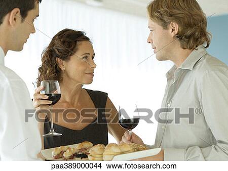 Woman smiling at man in cocktail party View Large Photo Image Picture - Woman smiling at man in cocktail party. Fotosearch