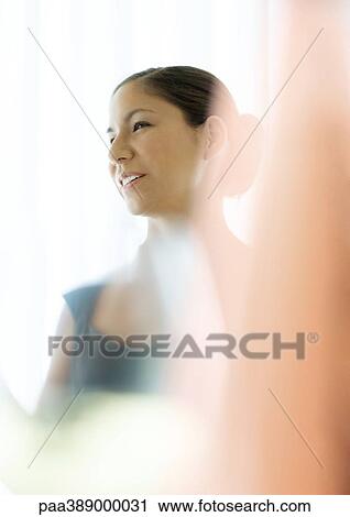 Woman smiling, blur in foreground View Large Photo Image Stock Image - Woman smiling, blur in foreground. Fotosearch