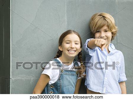 Boy and girl, boy pointing at camera View Large Photo Image Stock Photo - Boy and girl, boy pointing at camera. Fotosearch