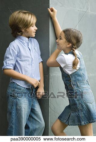 Boy and girl standing face to face, portrait View Large Photo Image Stock Photography - Boy and girl standing face to face, portrait. Fotosearch