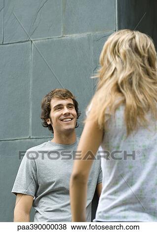 Young man and woman standing face to face View Large Photo Image Stock Photo - Young man and woman standing face to face. Fotosearch