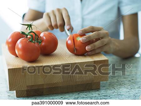 Cutting up tomatoes View Large Photo Image Stock Photo - Cutting up tomatoes. Fotosearch