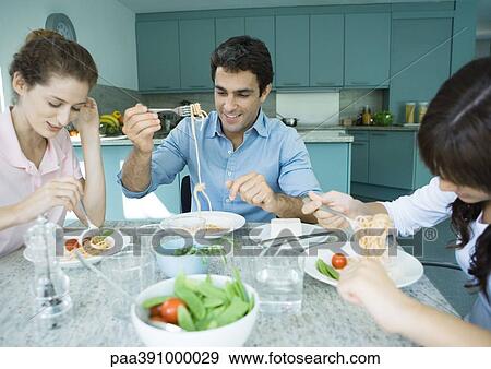 Family having meal together View Large Photo Image Stock Photo - Family having meal together. Fotosearch