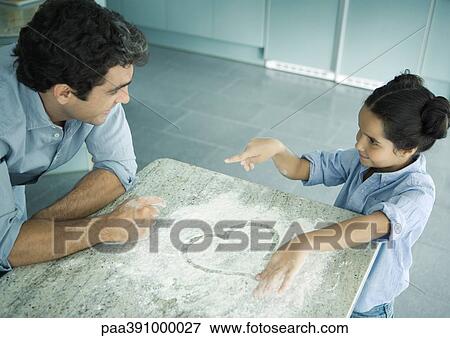 Father and daughter cooking together, heart drawn in flour on counter View Large Photo Image Stock Photo - Father and daughter cooking together, heart drawn in flour on counter. Fotosearch