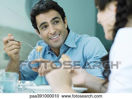 Father and daughter eating pasta View Large Photo Image Stock Image - Father and daughter eating pasta. Fotosearch