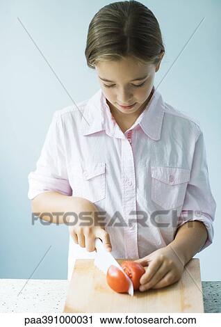 Girl cutting up tomato View Large Photo Image Stock Image - Girl cutting up tomato. Fotosearch