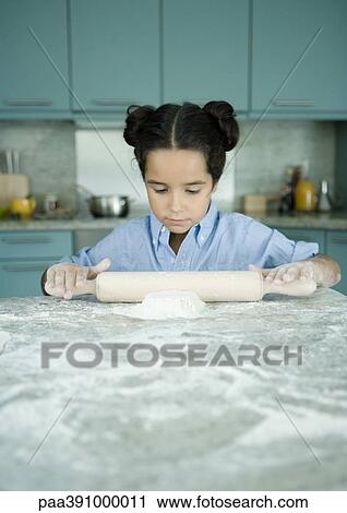 Stock Image - Girl making dough. Fotosearch