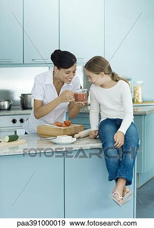 Mother and daughter cooking in kitchen View Large Photo Image Stock Photo - Mother and daughter cooking in kitchen. Fotosearch