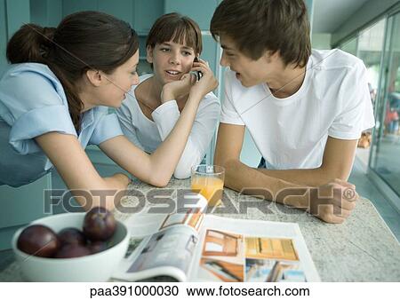 Woman and teenage children standing in kitchen View Large Photo Image Stock Image - Woman and teenage children standing in kitchen. Fotosearch