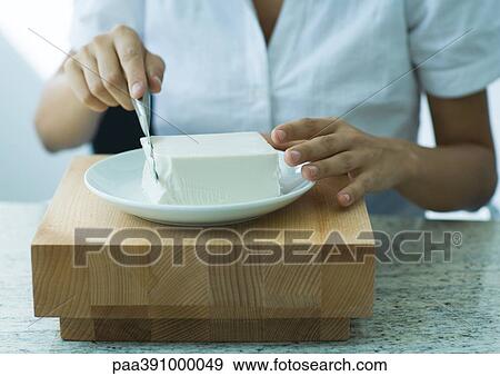 Woman cutting cube of cheese View Large Photo Image Stock Photo - Woman cutting cube of cheese. Fotosearch
