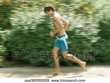 Boy in swimming trunks running View Large Photo Image Stock Photo - Boy in swimming trunks running. Fotosearch