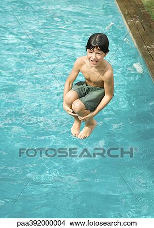 Boy jumping into pool View Large Photo Image Picture - Boy jumping into pool. Fotosearch