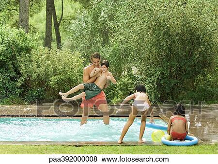 Father playing with children in swimming pool View Large Photo Image Stock Photo - Father playing with children in swimming pool. Fotosearch