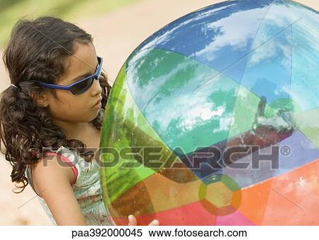 Girl holding beach ball View Large Photo Image Stock Photography - Girl holding beach ball. Fotosearch