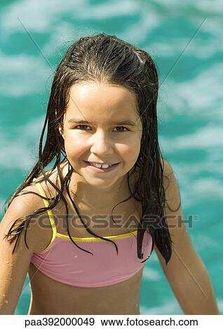 Girl in bathing suit, water in background, portrait View Large Photo Image Stock Photo - Girl in bathing suit, water in background, portrait. Fotosearch