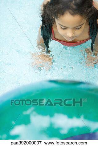 Girl in swimming pool, view from directly overhead, part of beach ball in blurred foreground View Large Photo Image Stock Photo - Girl in swimming pool, view from directly overhead, part of beach ball in blurred foreground. Fotosearch