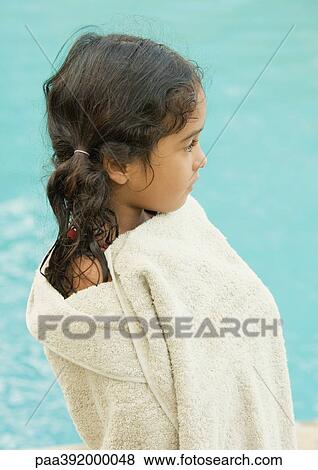 Stock Photo - Girl wrapped in towel, water in background. Fotosearch