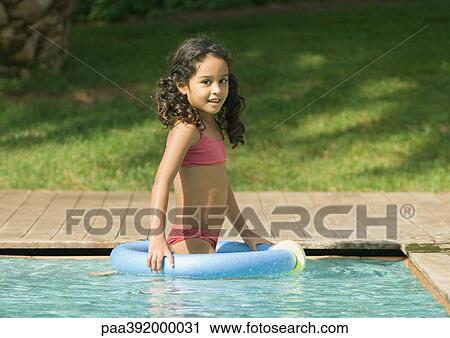 Little girl in swimming pool with floating ring View Large Photo Image Stock Image - Little girl in swimming pool with floating ring. Fotosearch