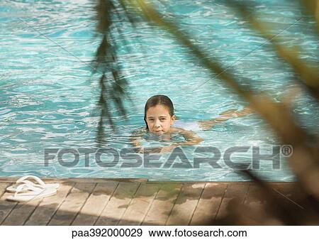 Little girl swimming in pool View Large Photo Image Stock Photo - Little girl swimming in pool. Fotosearch