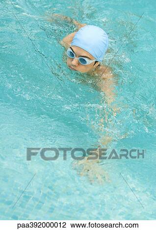 Person in swimming pool wearing bathing cap and goggles View Large Photo Image Stock Image - Person in swimming pool wearing bathing cap and goggles. Fotosearch