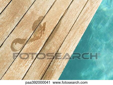 Stock Image - Wet footprint by edge of pool. Fotosearch
