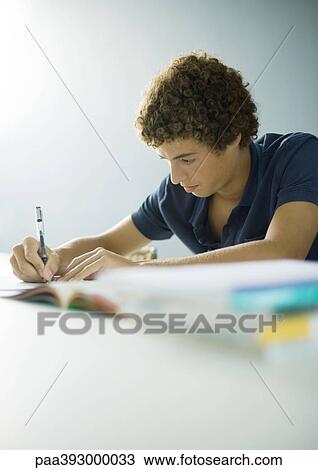 Adolescent boy doing homework View Large Photo Image Stock Image - Adolescent boy doing homework. Fotosearch