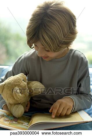 Child reading book to teddy bear View Large Photo Image Picture - Child reading book to teddy bear. Fotosearch