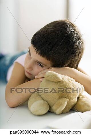 Child resting head on teddy bear View Large Photo Image Picture - Child resting head on teddy bear. Fotosearch