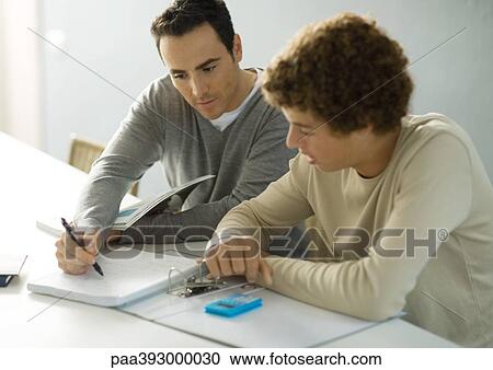 Father helping teenage son with homework View Large Photo Image Stock Image - Father helping teenage son with homework. Fotosearch