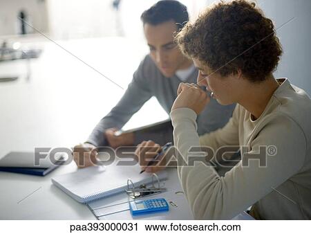 Father helping teenage son with homework View Large Photo Image Stock Image - Father helping teenage son with homework. Fotosearch