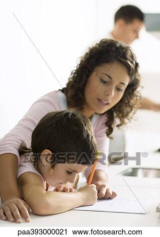 Mother helping child with homework View Large Photo Image Stock Image - Mother helping child with homework. Fotosearch