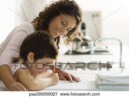 Stock Photo - Mother helping child with homework. Fotosearch