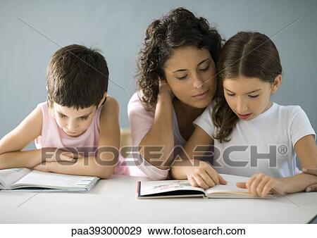 Mother helping children with homework View Large Photo Image Stock Photo - Mother helping children with homework. Fotosearch