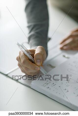 Person's hand posed over notebook with math notes View Large Photo Image Picture - Person's hand posed over notebook with math notes. Fotosearch