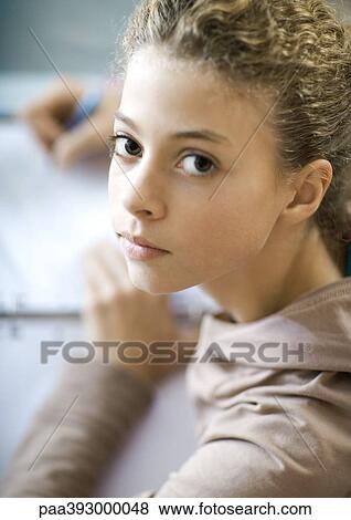 Preteen girl doing homework, portrait View Large Photo Image Stock Photo - Preteen girl doing homework, portrait. Fotosearch