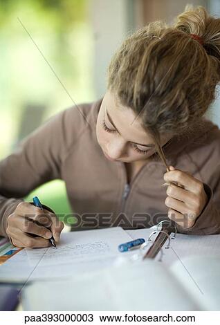 Preteen girl doing homework View Large Photo Image Stock Image - Preteen girl doing homework. Fotosearch