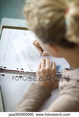 Stock Image - Preteen girl doing homework. Fotosearch