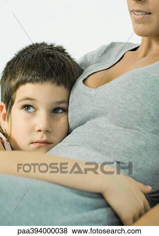 Child leaning against mother, hand around her waist View Large Photo Image Stock Photo - Child leaning against mother, hand around her waist. Fotosearch