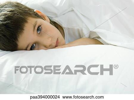Child lying in bed View Large Photo Image Picture - Child lying in bed. Fotosearch